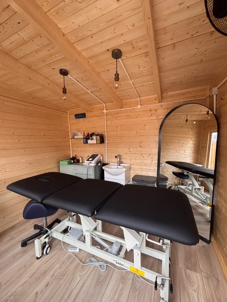 Sports therapy treatment couch and equipment inside the garden studio