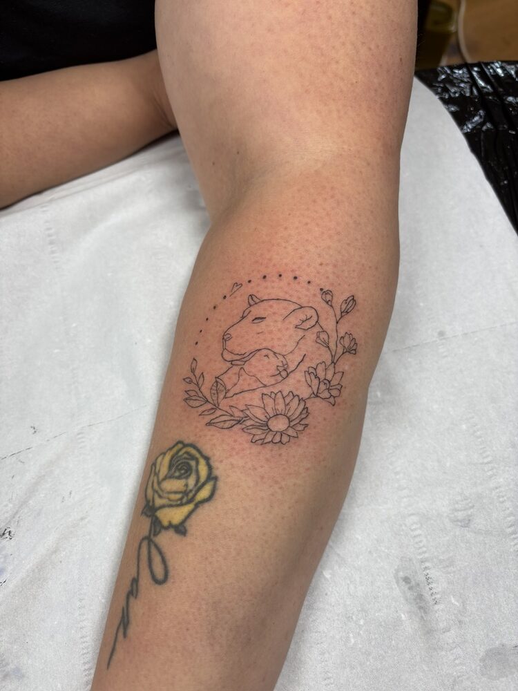 Fine line capybara and floral tattoo on the forearm